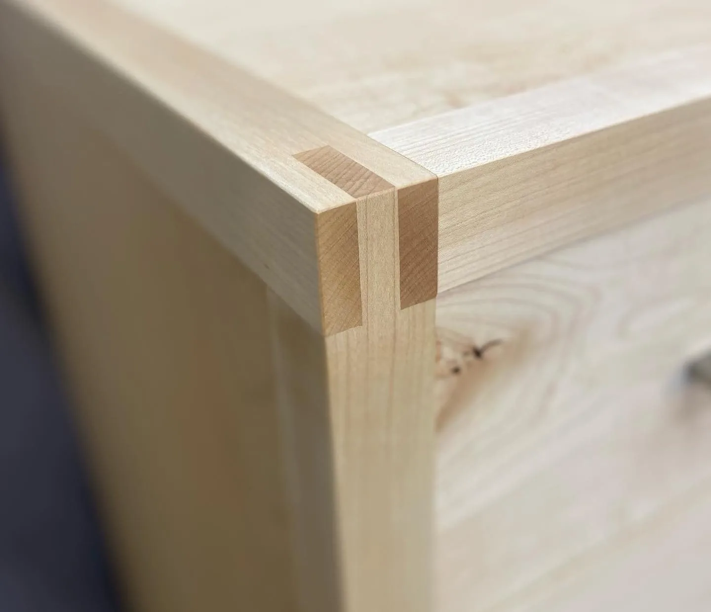 Close-up of a joined hardwood corner, showing the joinery on a finished piece