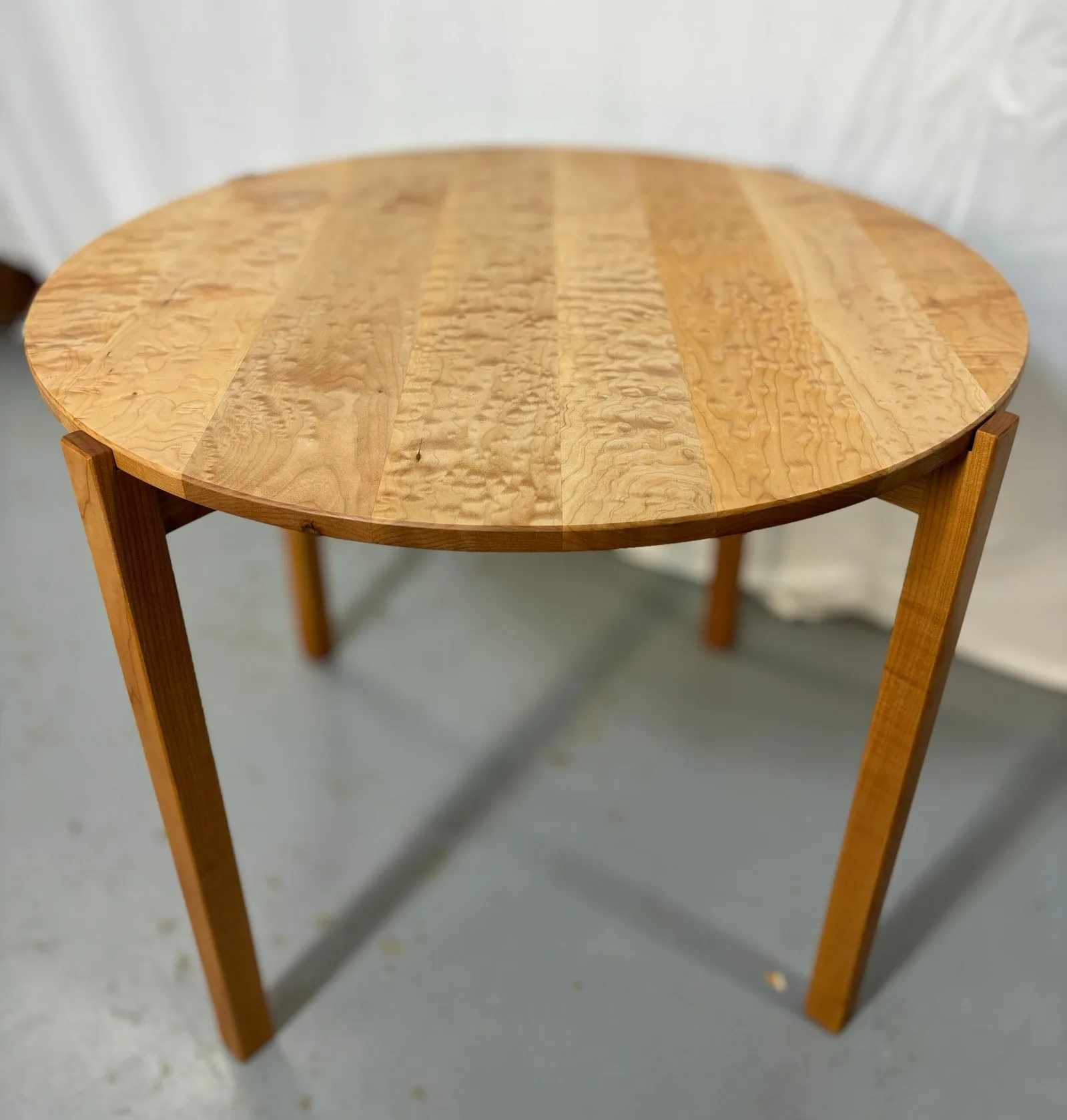 Ramona Dining Table with a round figured maple top by PDX Woodworks