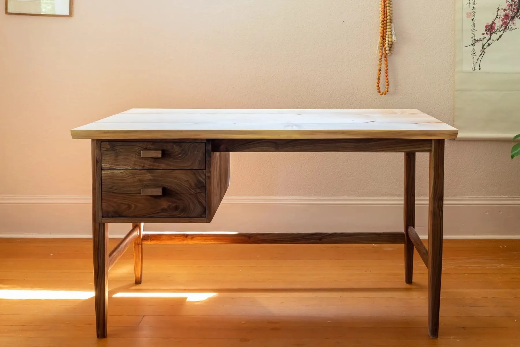 Custom walnut desk with a light maple top, in a client's home